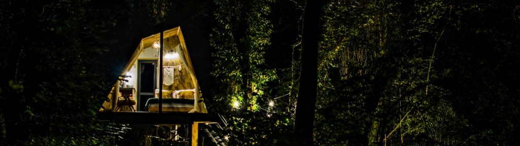 Luxury Treehouse in the dark with its lights on
